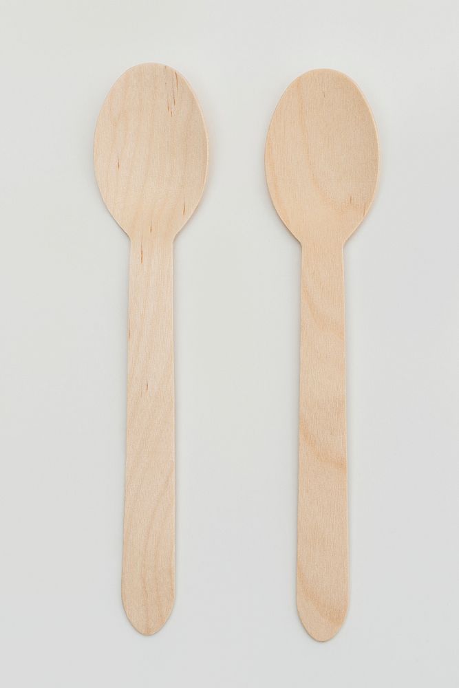 Natural wooden spoons on off white background