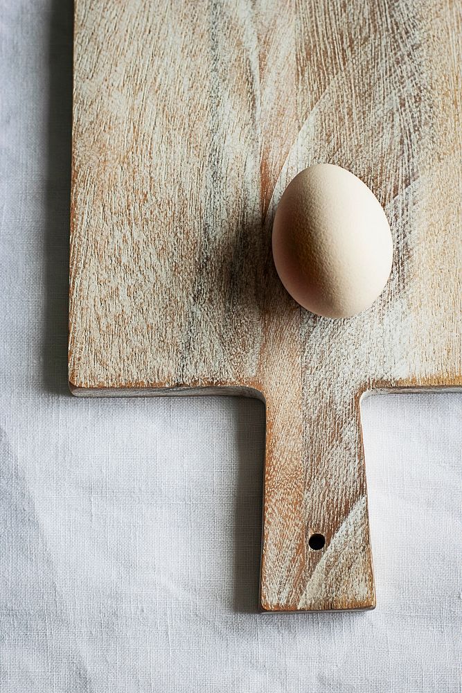 Fresh organic egg on a wooden board