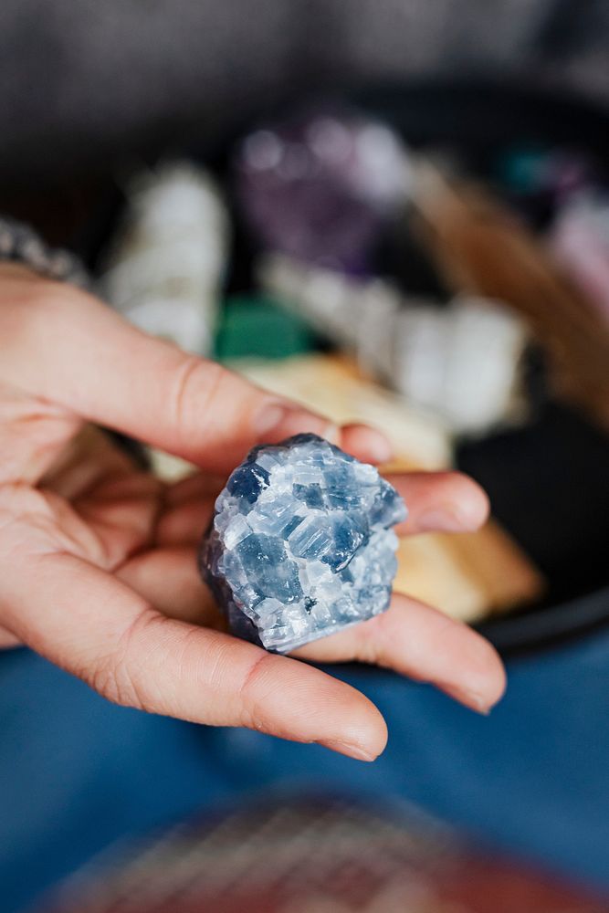 Woman with blue calcite healing crystal 