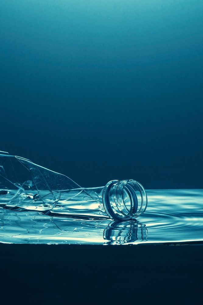 Single use plastic bottle floating in the ocean