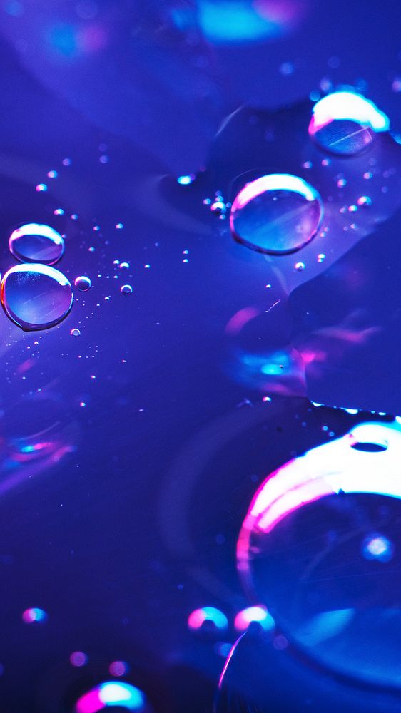 Oil drops floating on water colorful background