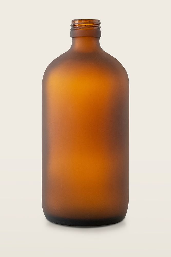 Empty brown glass bottle on off white background