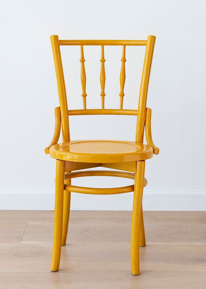 Vintage yellow wooden chair on wooden floor