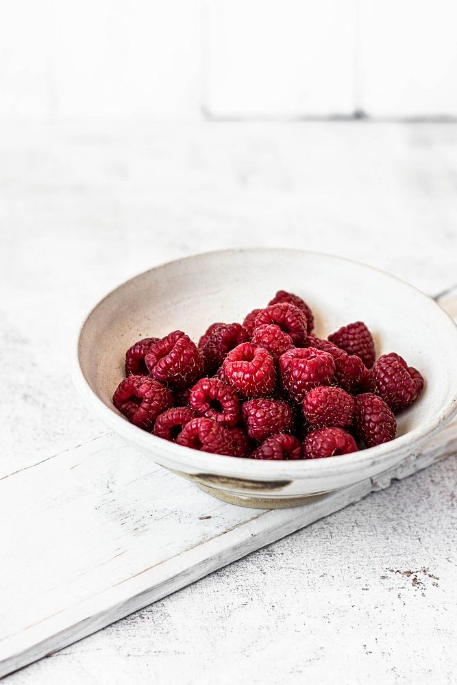 Fresh organic raspberry in a white bowl