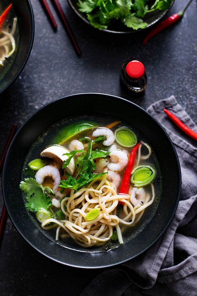 Authentic Asian noodle soup in a black bowl