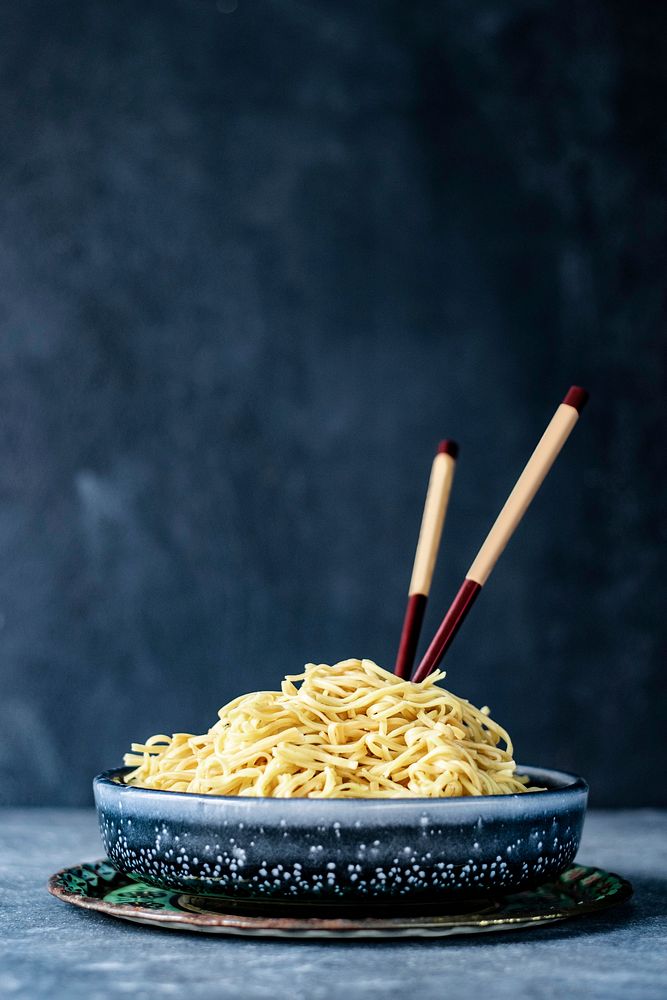 Wooden chopsticks in a noodle bowl
