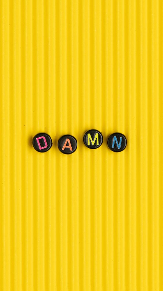 DAMN beads message typography on yellow