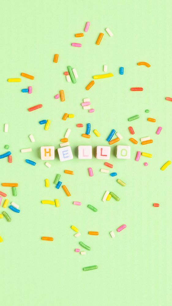 HELLO beads text typography on green sprinkles background