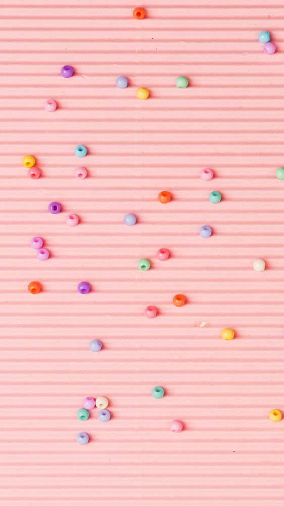 Beads on pink wavy paper phone wallpaper