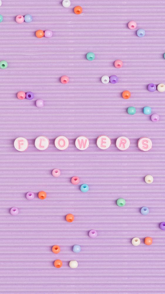 Flowers typography beads alphabet purple background