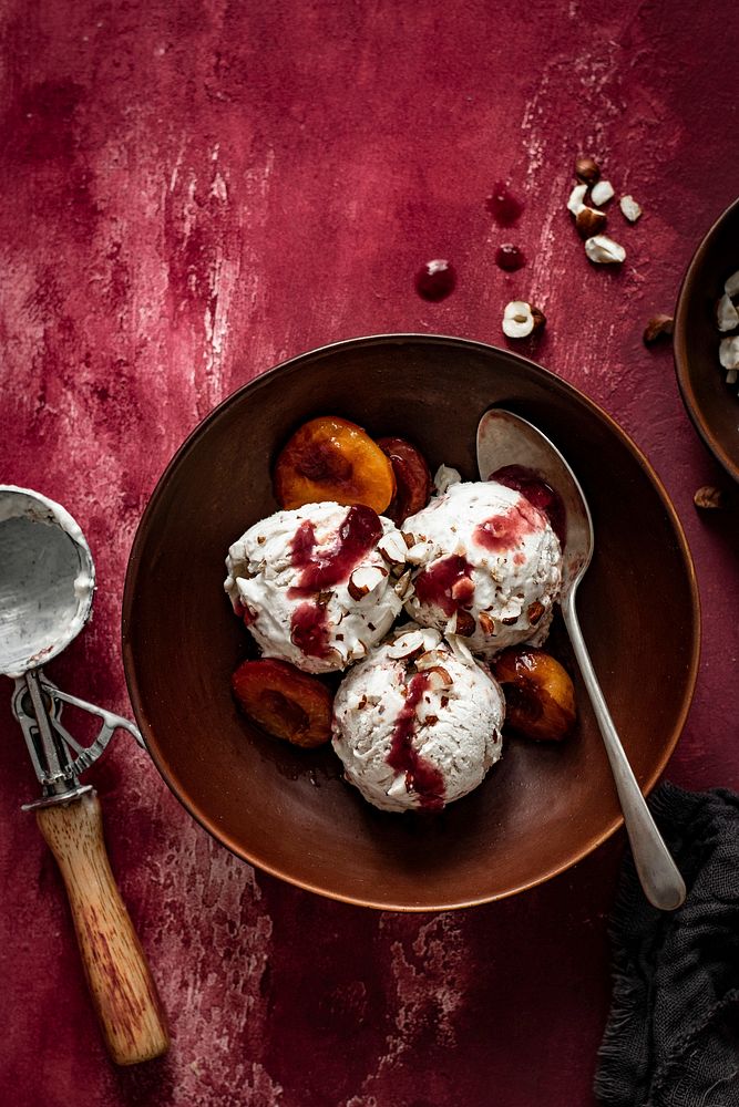 Roasted plums ice cream on red table