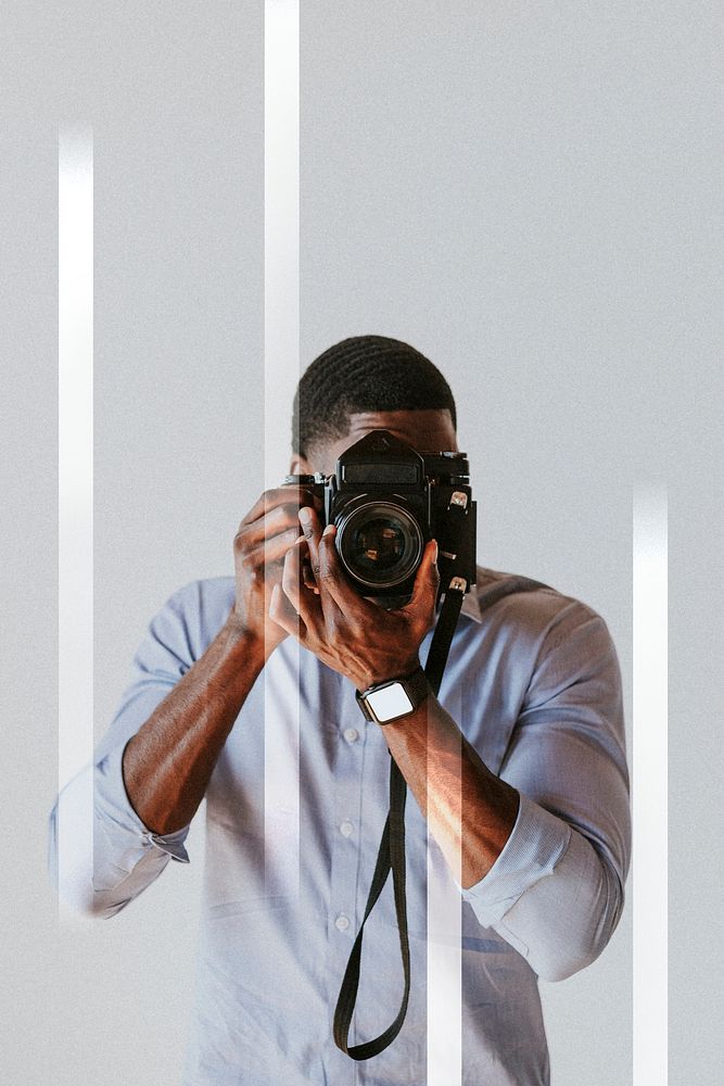 Black photographer capturing a picture with a retro film camera
