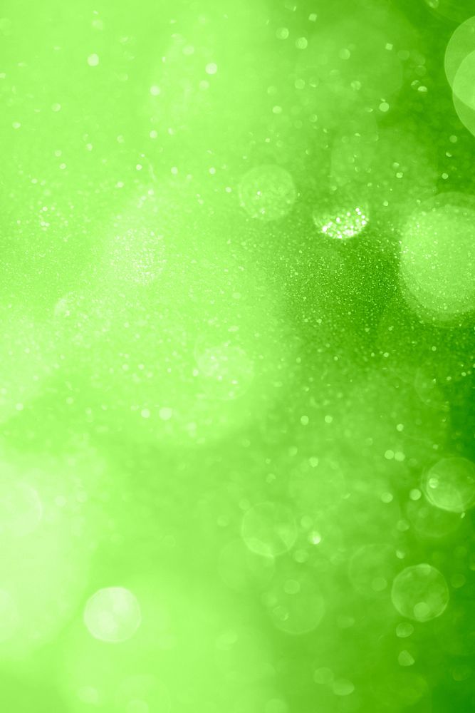 Glittery bokeh pattern on a green background