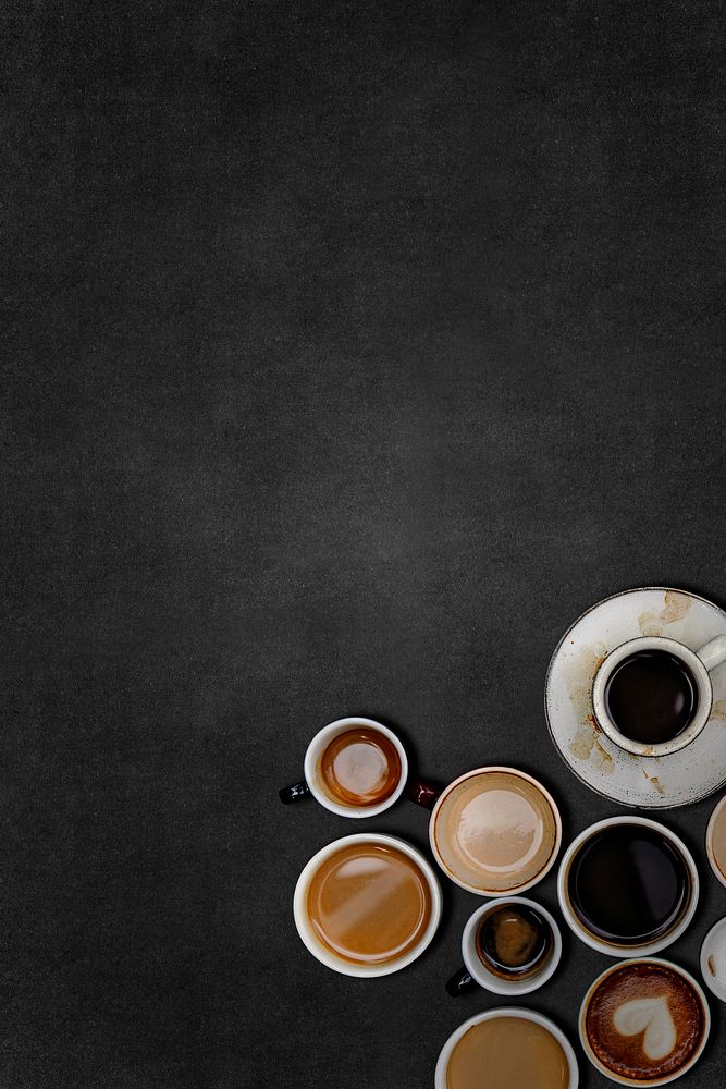 Coffee cups on a black textured wallpaper 