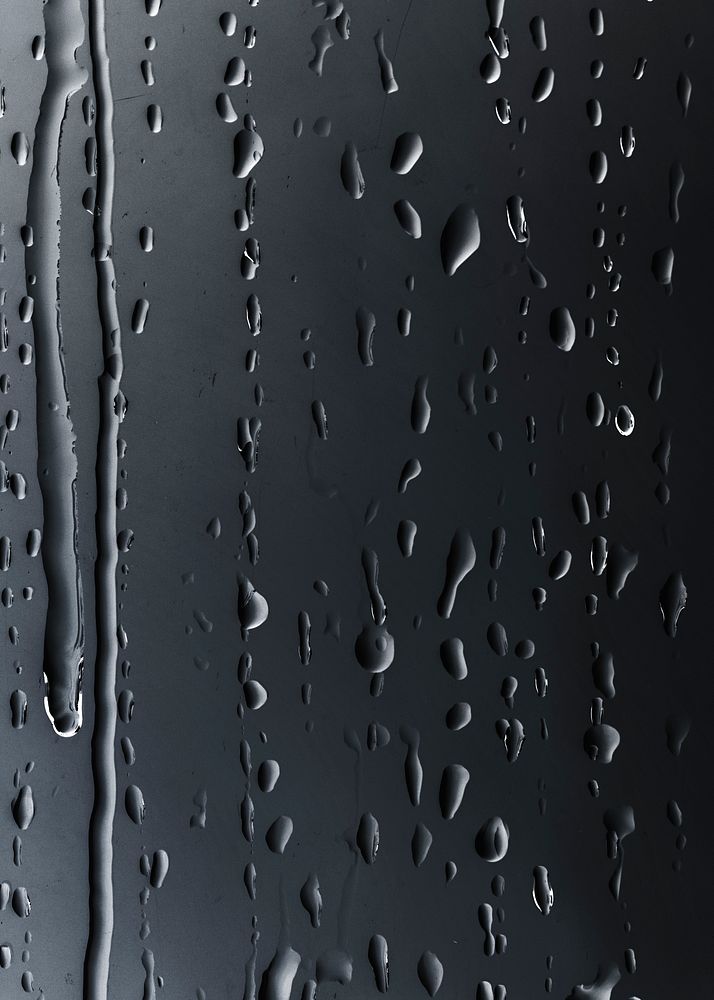 Rain drops on glass black background