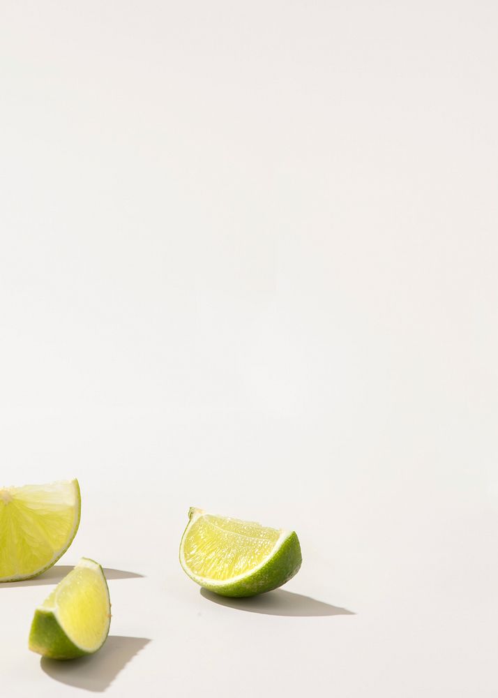 Slices of fresh green lime on white background