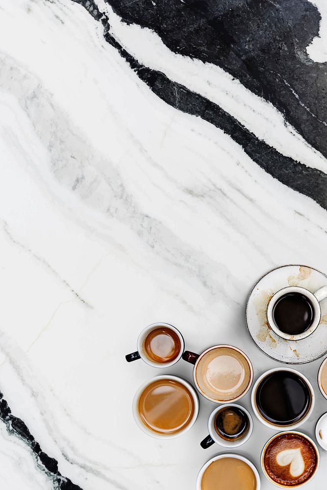Mixed coffee cups on a black and white marble textured wallpaper