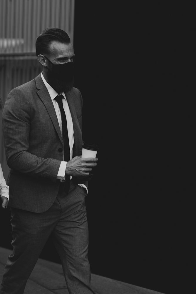 Businessman wearing face mask during coronavirus pandemic monochrome