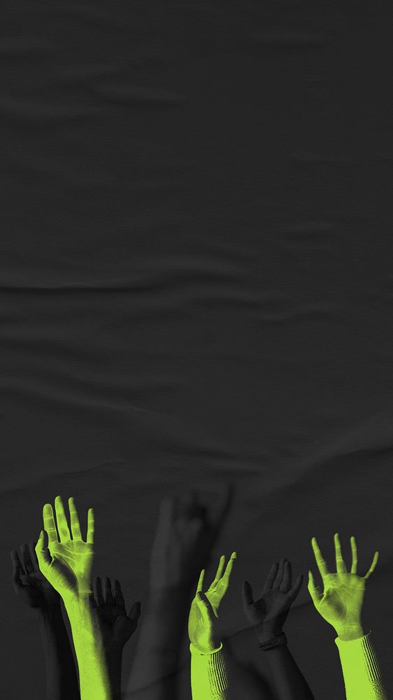 Green arms raising on black paper textured background