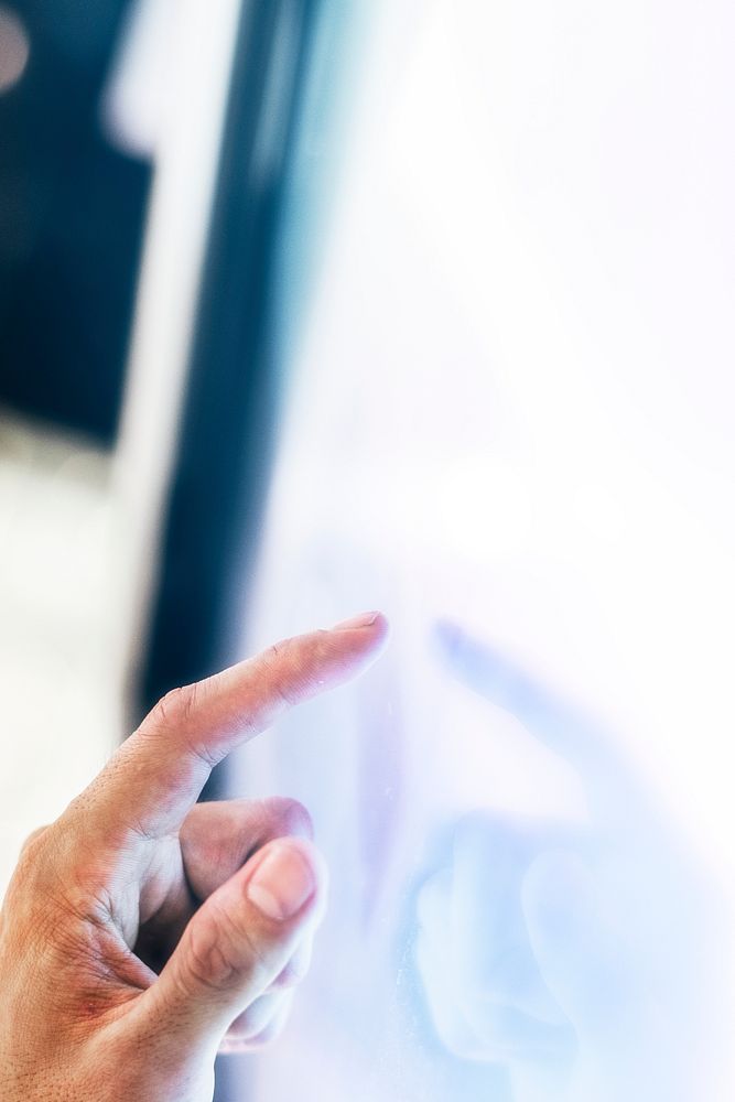 Man working on a a large white digital screen