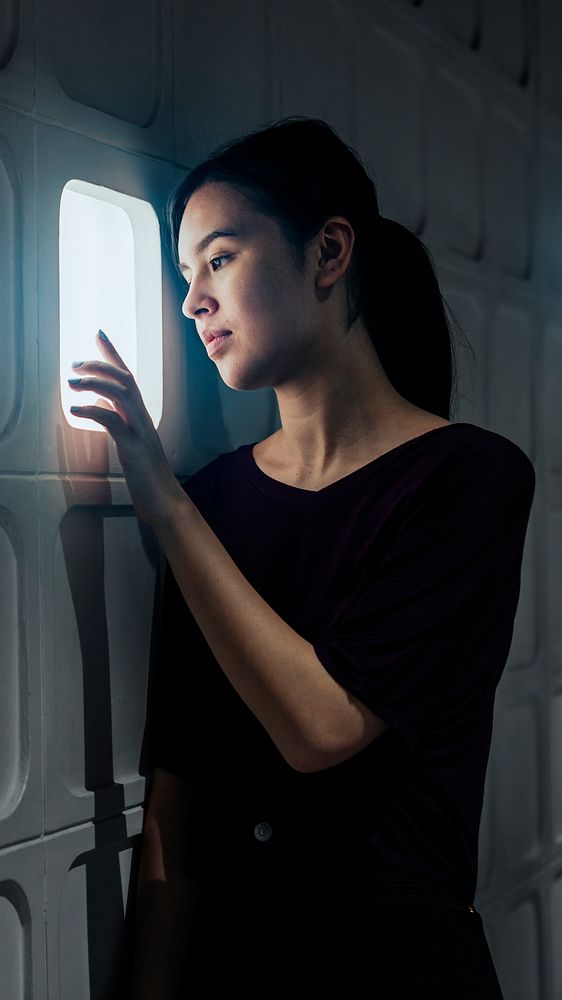 Girl isolated in a sound proof concrete cell