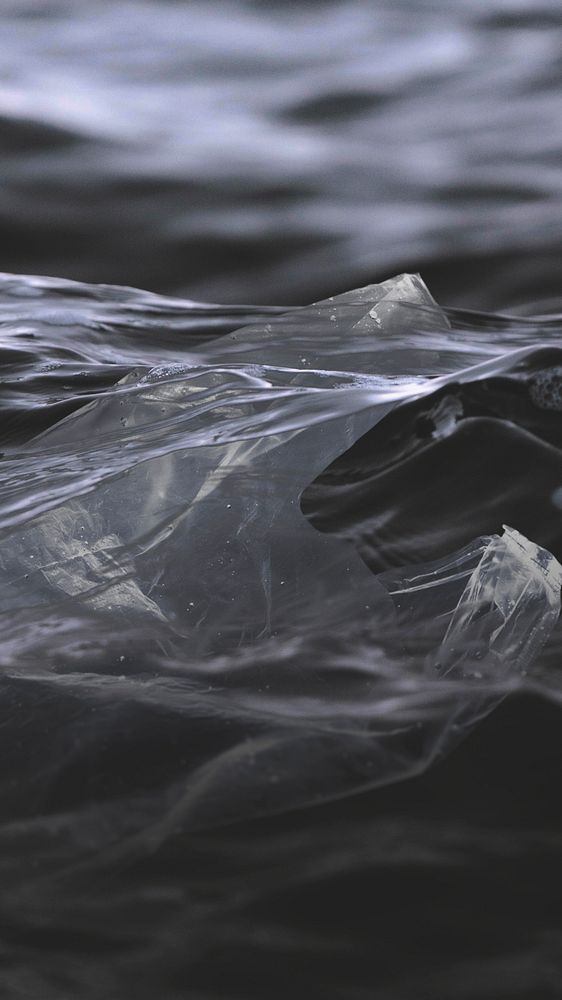 Plastic bags in the black ocean