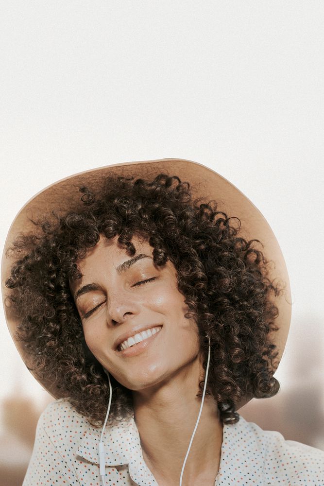 Woman with curly hair wearing earphones remixed media