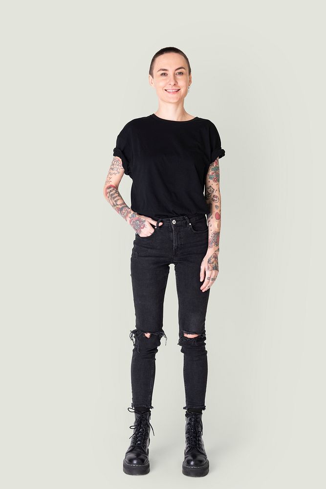 Model with tattoo in black T shirt and jeans