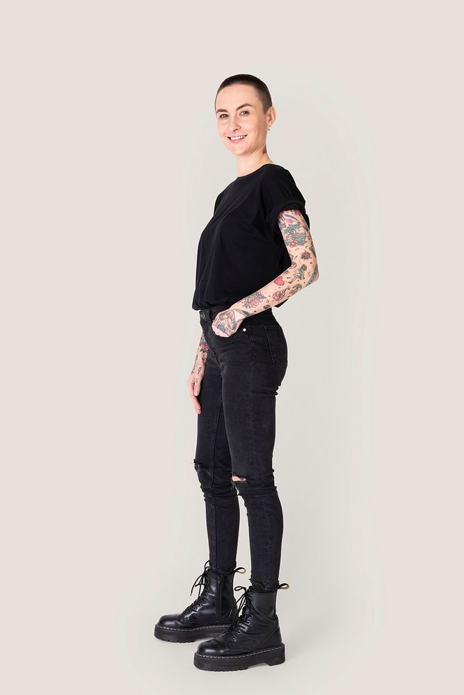 Tattooed woman in black t-shirt and jeans 