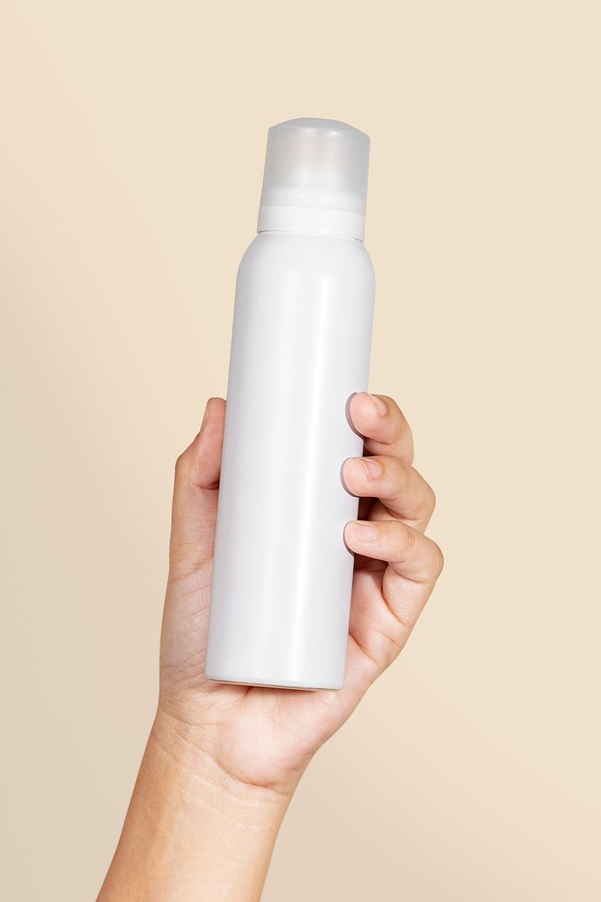 Black woman holding a white spray bottle psd