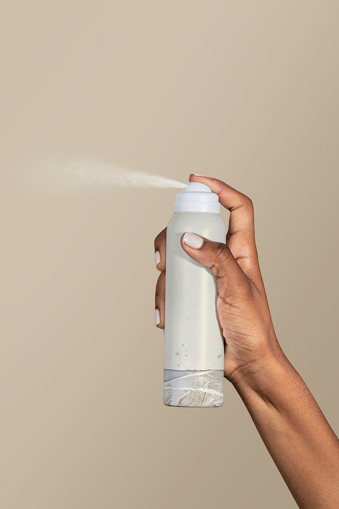 Black woman using a spray bottle