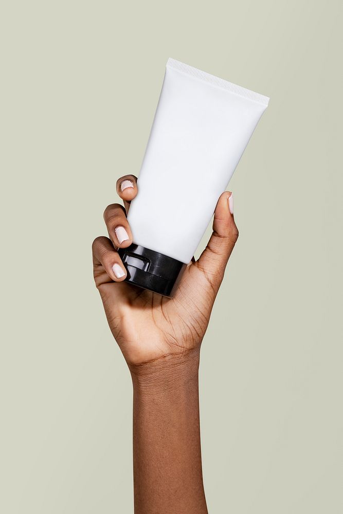 Black woman holding a cream tube 
