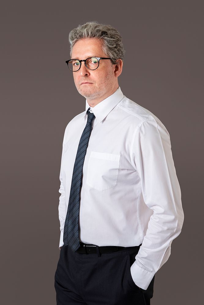 Businessman portrait on a gray wall