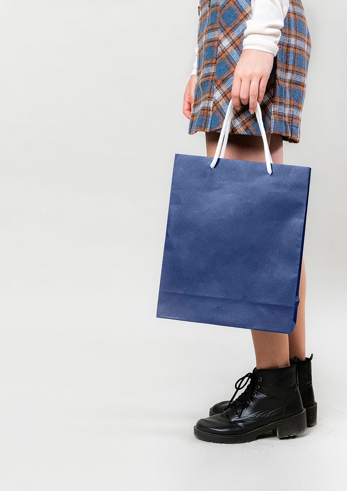 Woman carrying a blue shopping bag