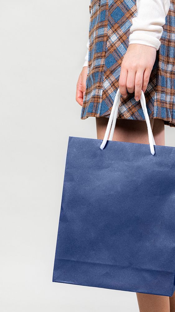 Woman carrying a blue shopping bag