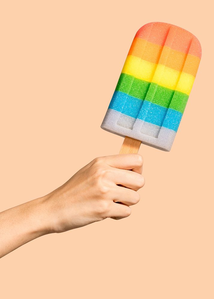 Hand with a rainbow ice pop in summertime mockup