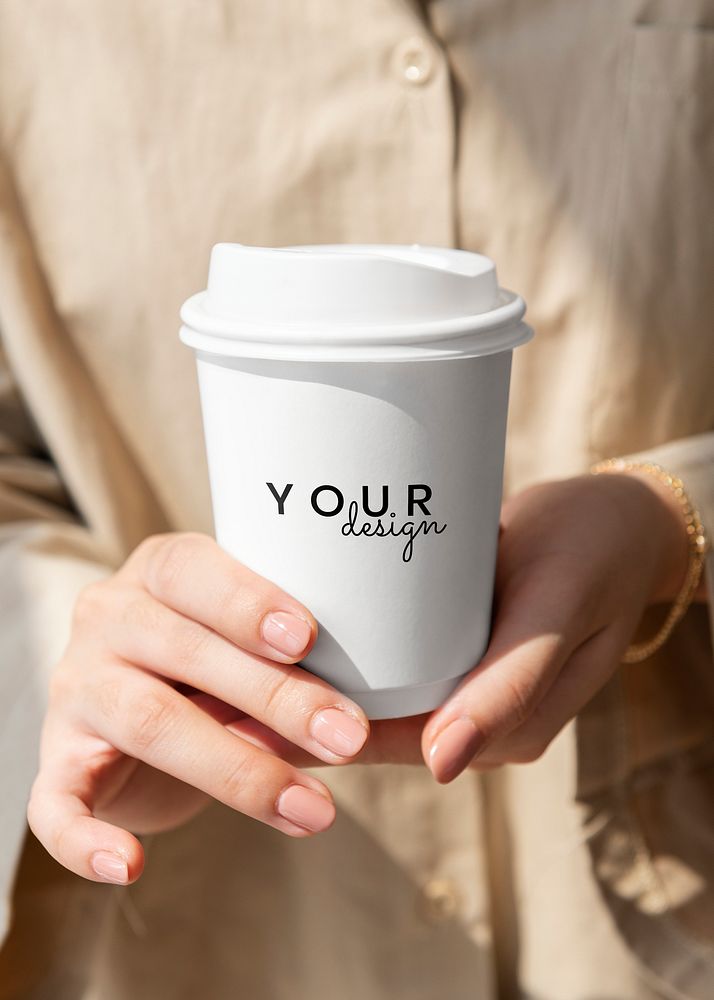Woman holding a coffee cup mockup