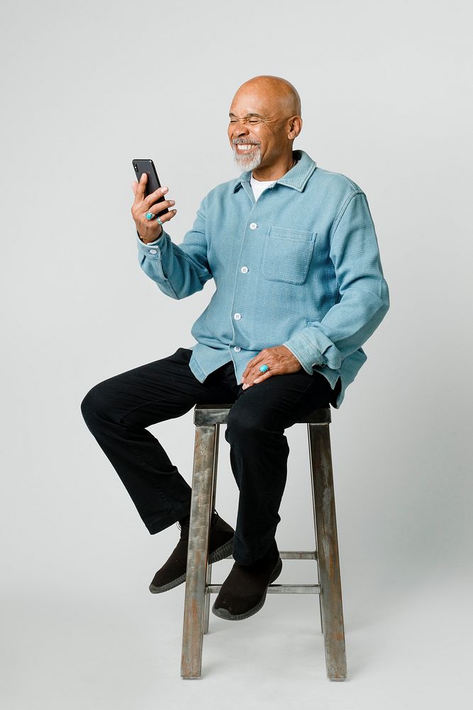 Happy retired man using a smartphone