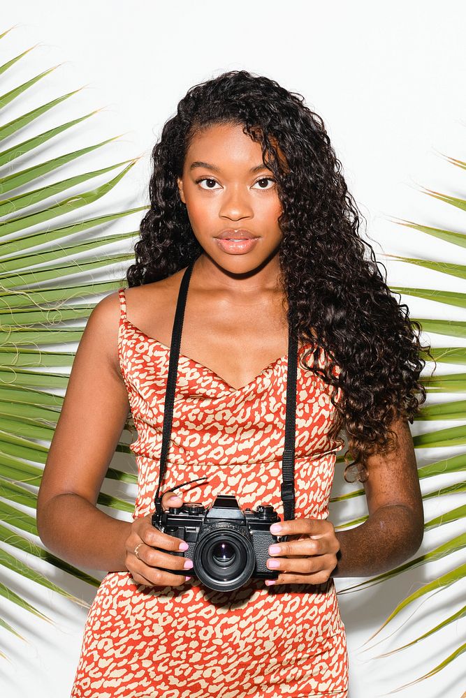 Beautiful black woman with an analog camera