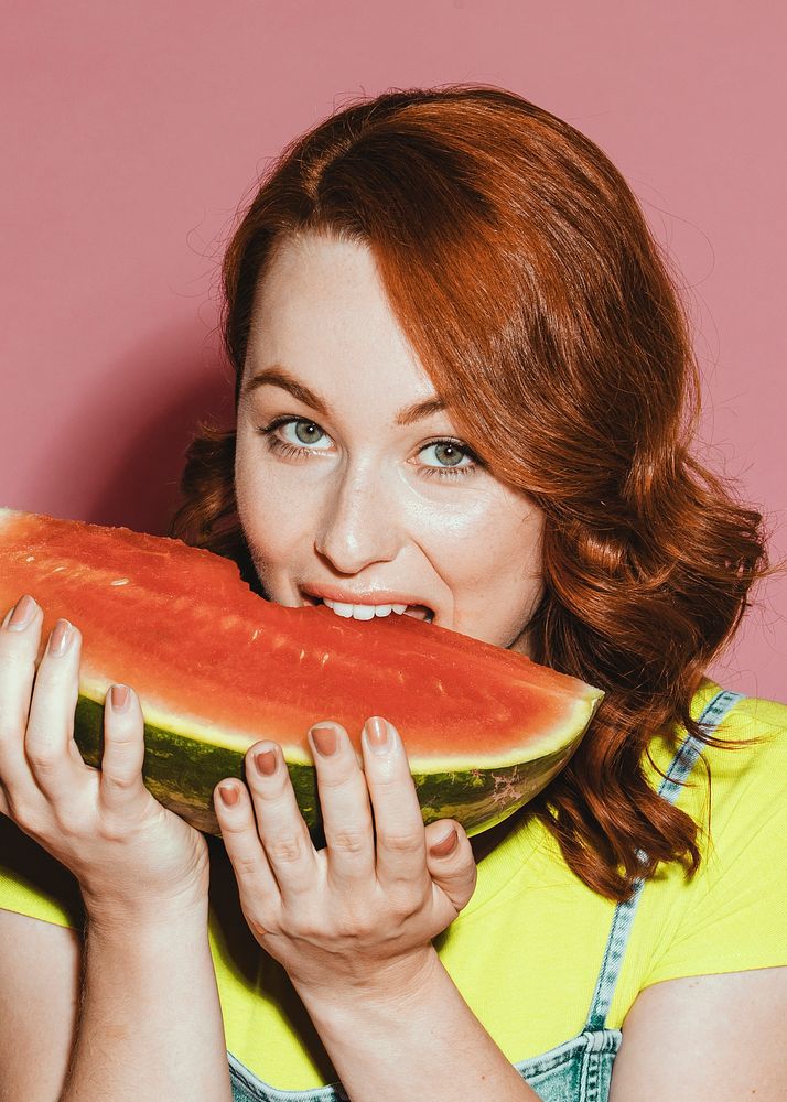 Woman biting into a slice of watermelon