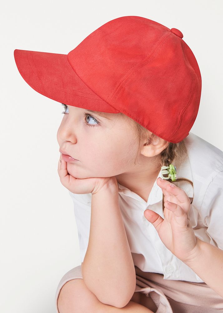 Girl wearing red cap in studio