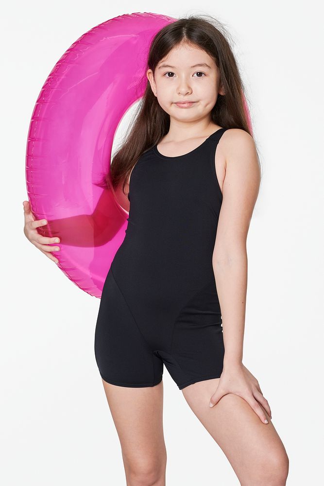 Girl wearing swimwear holding a inflatable tube