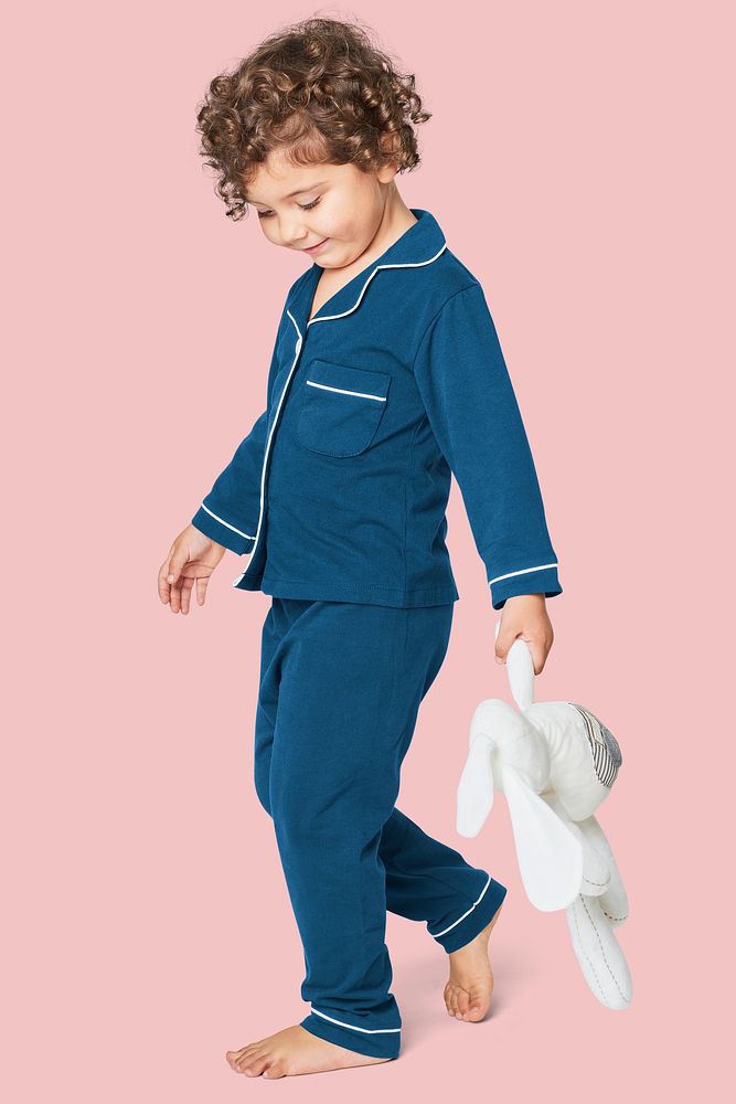 Girl in blue pajamas with a plush bunny