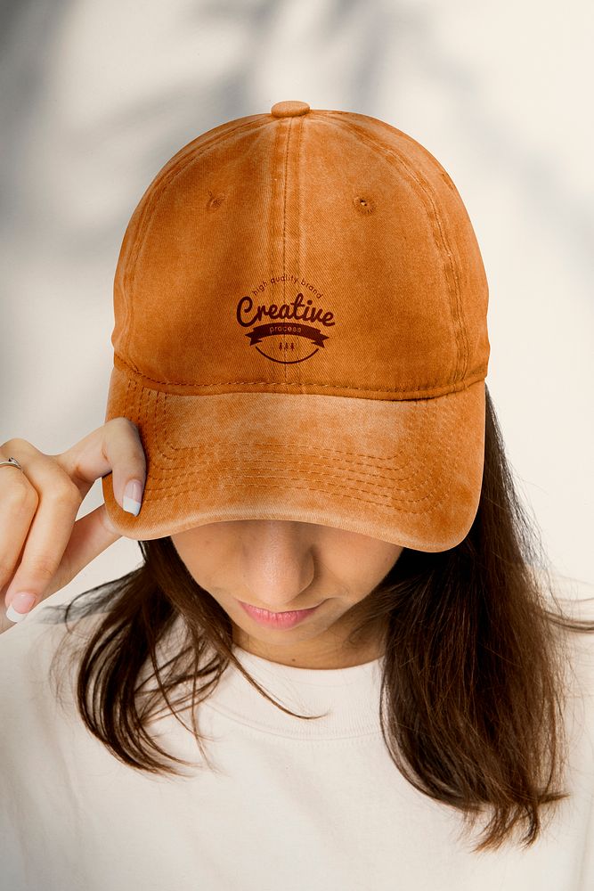 Beautiful woman in baseball cap, headband fashion studio shoot