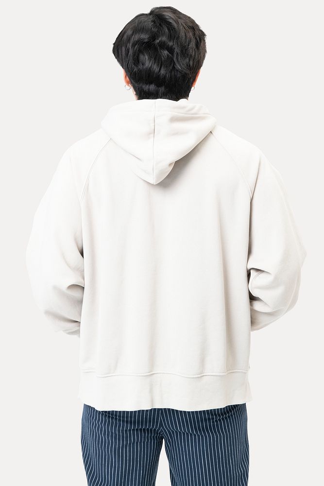 Handsome man wearing white hoodie for winter fashion studio shoot rear view