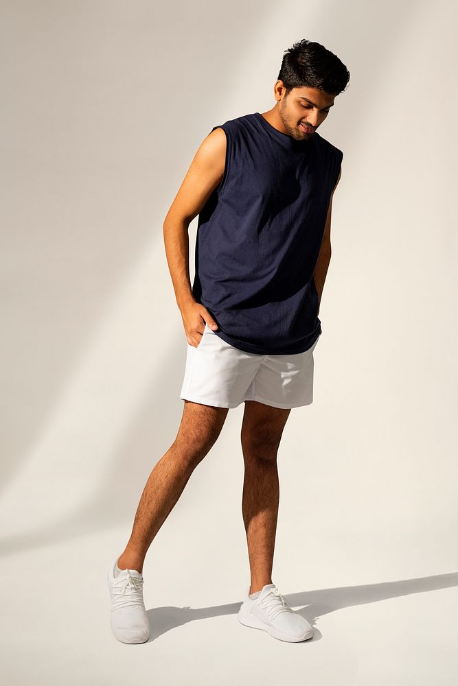 Man in navy tank top and shorts sportswear apparel full body