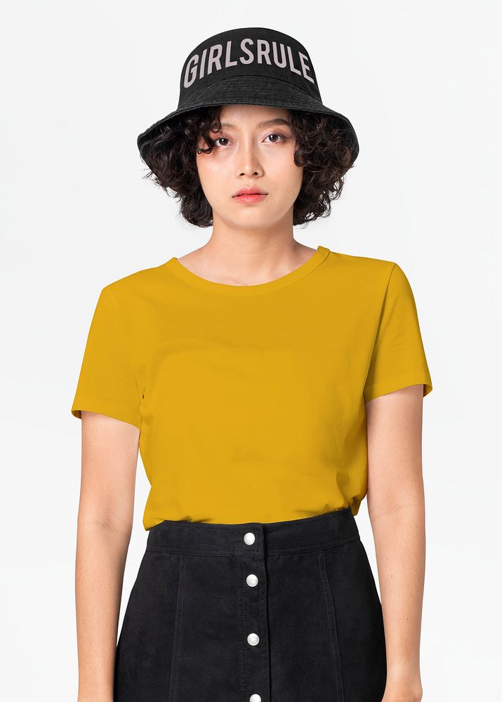 Woman in yellow tee and Girls Rule bucket hat streetwear fashion