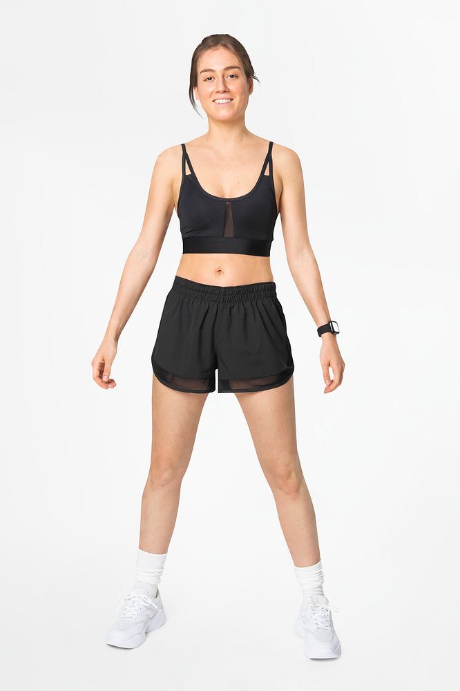 Woman in black sports bra and shorts activewear apparel full body