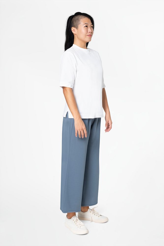 Woman in white tee and blue loose pants minimal fashion