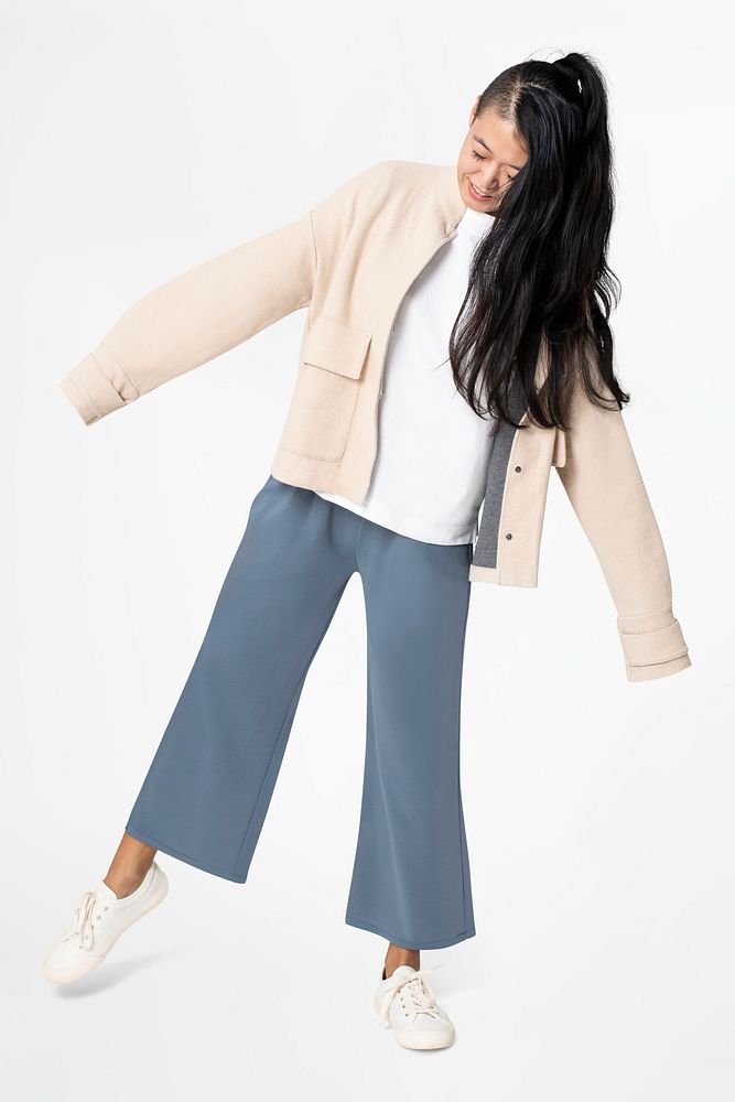 Woman posing in beige jacket and blue pants casual wear fashion